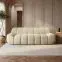 Macy large 3 seater sofa in cream textured fabric with sculpted panel design in a modern living room
