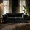 3 seater black velvet sofa with minimalist design and deep cushioned seating
