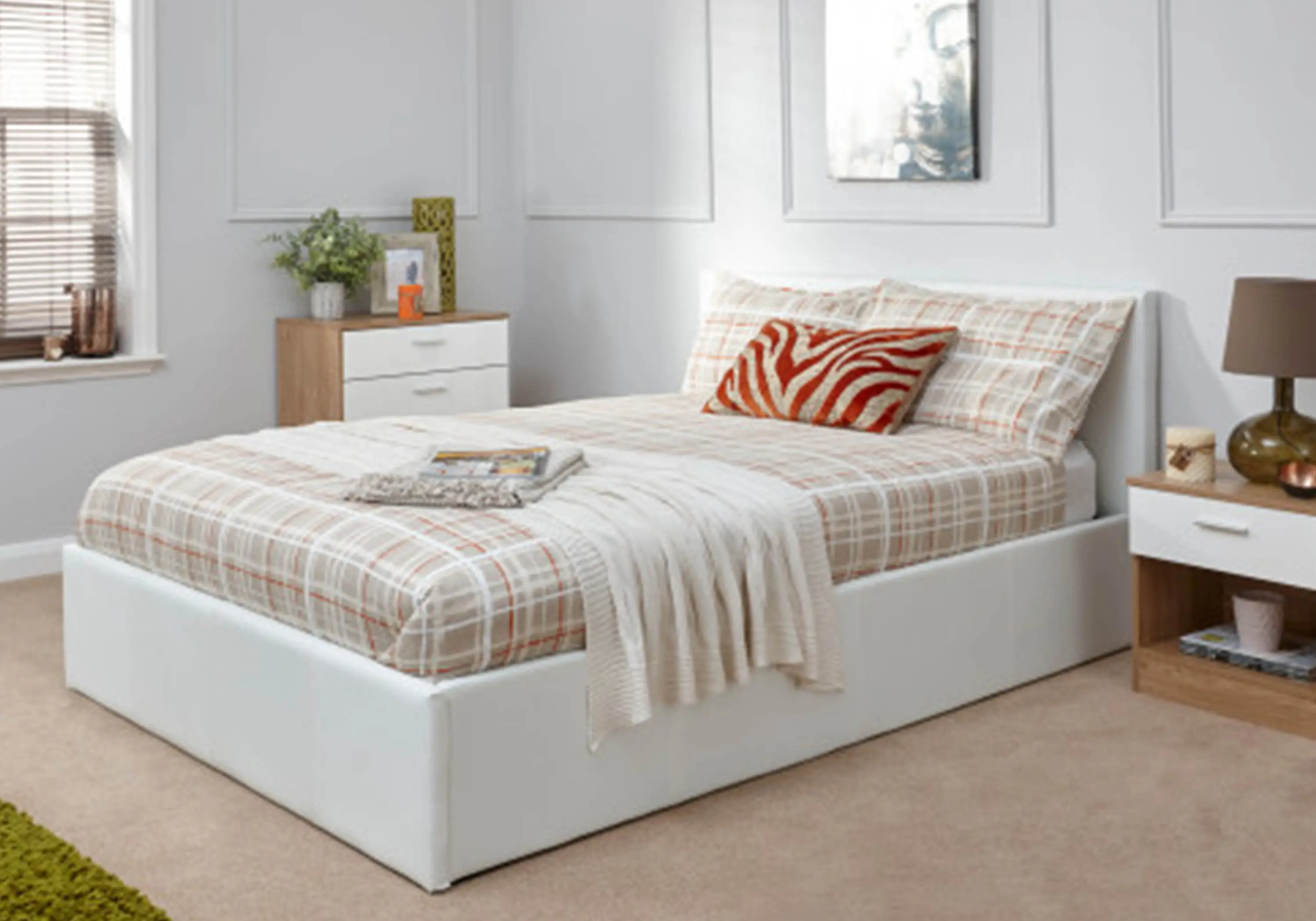 White ottoman bed with checkered brown sheets and natural/white wood furniture
