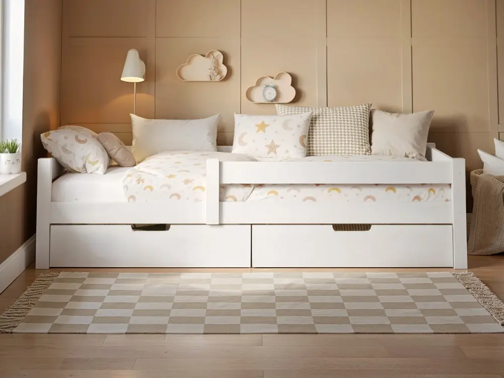 Wooden single bed with two pull-out storage drawers, styled in a neutral children’s bedroom with striped feature wall and soft patterned bedding