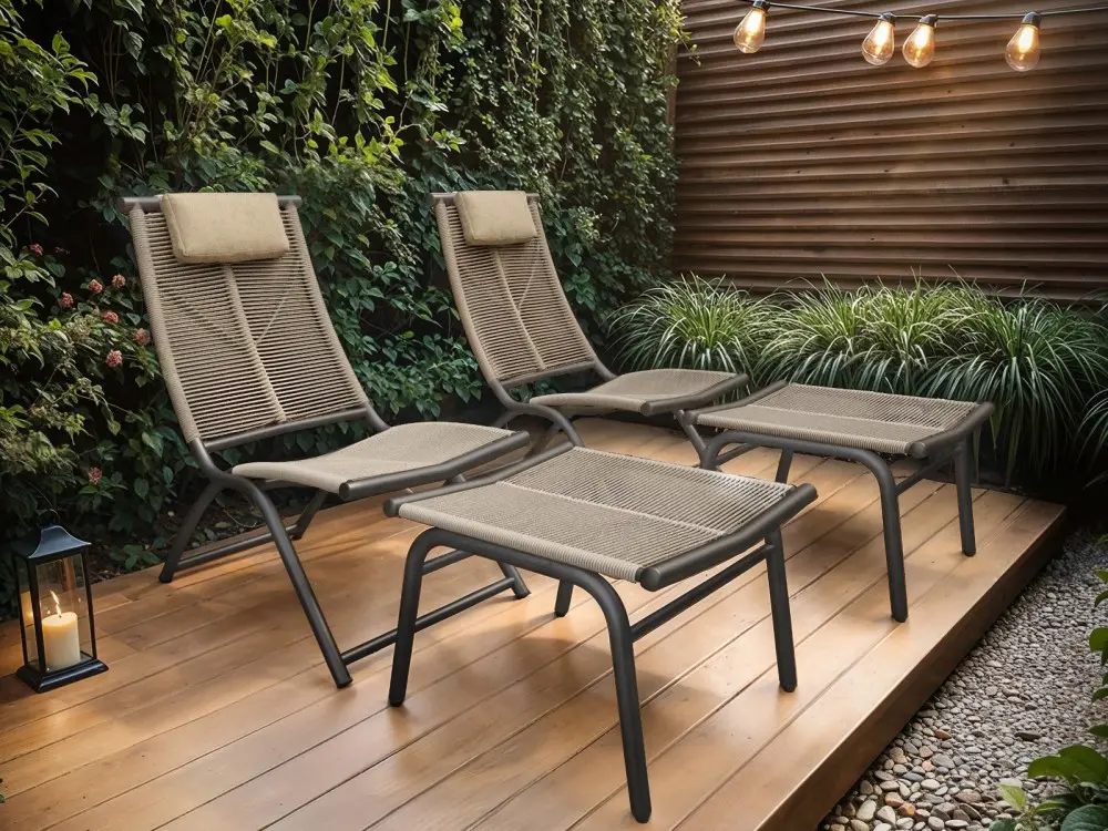 Garden lounge chairs with matching footstools on a wooden deck in a modern outdoor setting
